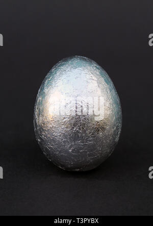 Easter silver Easter egg isolated on white background eggs and daffodils Stock Photo