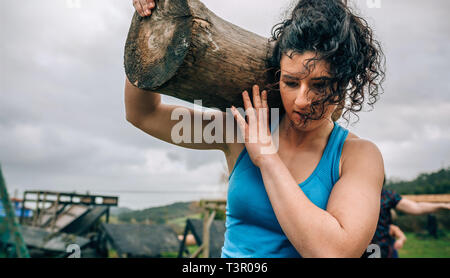 Woman carrying a trunk Stock Photo