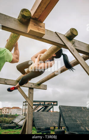 Participant in a obstacle course doing weaver Stock Photo