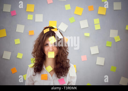 secretary overwhelmed with sticky reminder notes Stock Photo