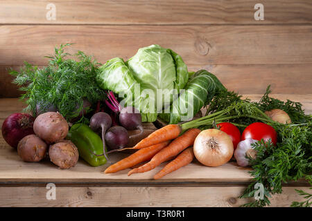 Heap of fresh organic vegetables on wooden table. Assortment of vegetables for cooking borscht. Сopy space Stock Photo