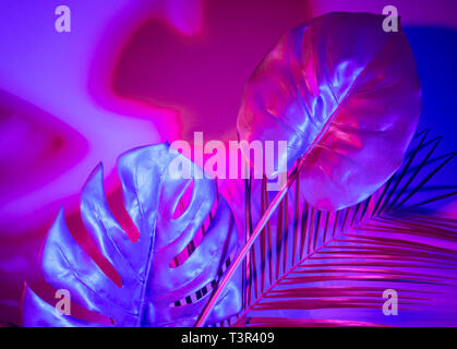 Creative tropic purple leaves layout. Supernatural concept. Flat lay. Ultra violet colors. Stock Photo