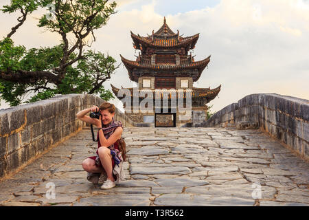 Girl tourist takes a picture in Chinese old town Stock Photo