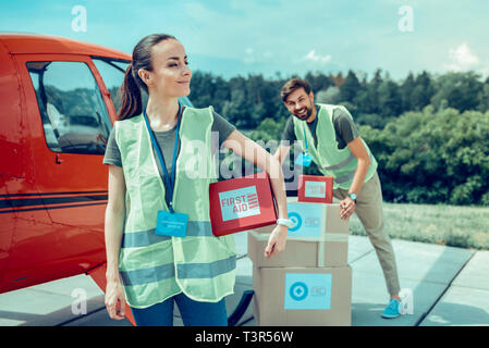 Resolute long-haired woman being proud of her work and activity Stock Photo