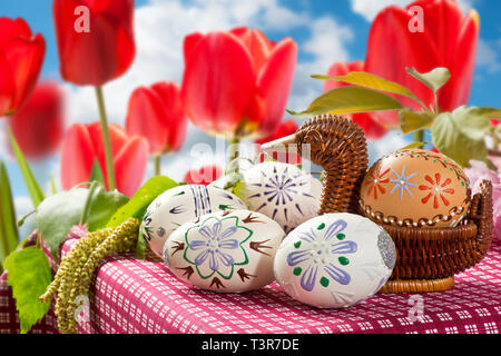 Painted Easter eggs with tulips in the garden Stock Photo