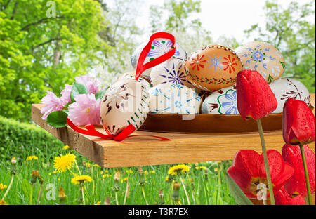 Painted Easter eggs with tulips in the garden Stock Photo
