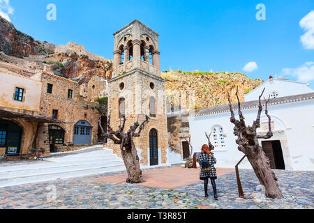 Monemvasia, Greece - March 31, 2019: Street panorama with old houses and Elkomenos Christos church in ancient town, Peloponnese, Greece Stock Photo