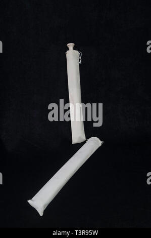 Standing on a black background, a white-colored instrument instruments flute wind intsrument Stock Photo