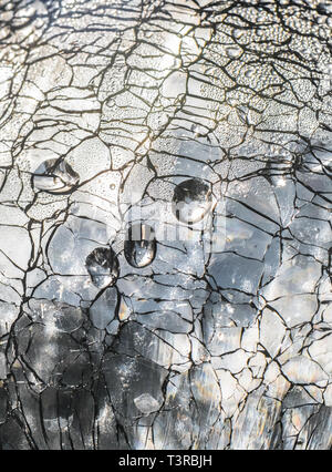 Water droplets on the surface of shattered glass. Stock Photo