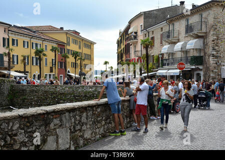 Tourists in the historical center of Sirmione on Lake Garda - Italy. Stock Photo