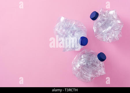 Disposable waste plastic bottles on pink background. Top view. Copyspace Stock Photo