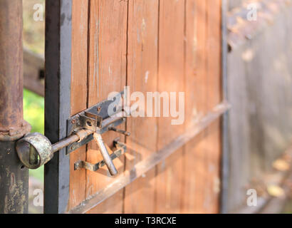 Padlock on outdoor door or gate, shallow depth of field, concept of safety Stock Photo