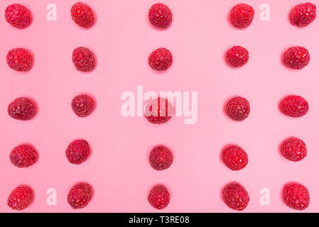 Pattern made from fresh raspberries, top view, flat lay pattern, isolated on a light pink background. Stock Photo