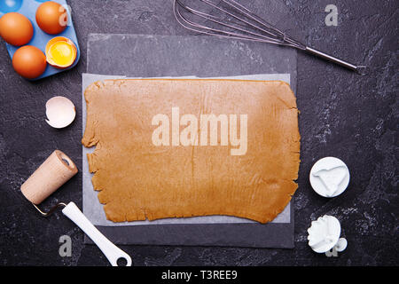 Ginger dough for cookies and molds in the form of a rocket and an alien Stock Photo