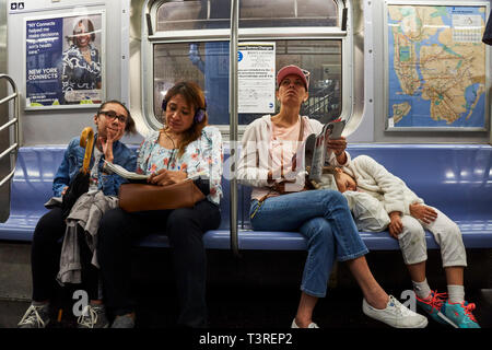 two mothers and their teenager kids riding into the NYC Subway, Stock Photo