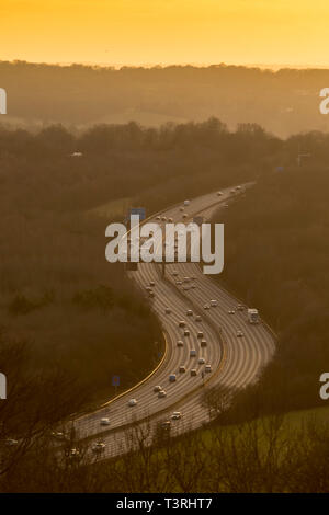 M25 motorway winding through landscape at dusk, Surrey, England Stock Photo