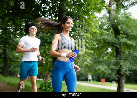 Beautiful couple jogging in nature living healthy Stock Photo - Alamy