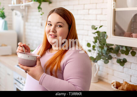Pleasant good looking woman eating her food Stock Photo