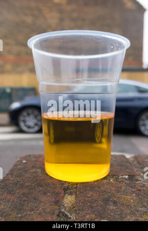 Parked car and a half empty plastic beaker of lager to illustrate the theme of drunk / drink driver, & driving while under the influence of alcohol. England UK (108) Stock Photo