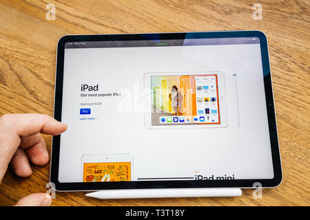 Paris, France Mar 27, 2019: Man hand POV looking at the new iPad Pro featuring Apple Computers website with latest most popular iPAd with 329 starting price point Stock Photo