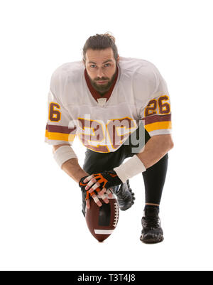 Bearded American football player sitting on his knee. Stock Photo