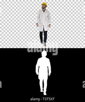 Engineer putting on protactive glasses while walking, Alpha Channel Stock Photo