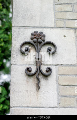 Forged metal flower on the wall of the old crypt Stock Photo