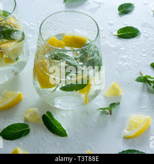 Refreshment ice drink/cocktail with raw lemons and mint Stock Photo