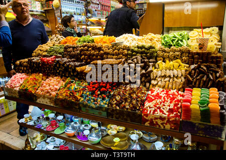 Istanbul,Turkey,March 07, 2019:inside of Egyptian Bazaar n front of store selling various colorful sweets, close up, with some customers inside Stock Photo