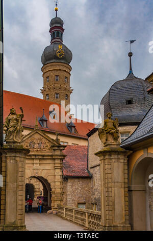 A portrait photo of the baroque entrance to Weikersheim Palace with the medieval keep on a cloudy rainy day in Weikersheim, Baden-Württemberg, Germany. Stock Photo