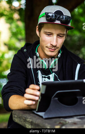 Caucasian man using digital tablet outdoors Stock Photo