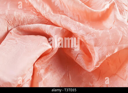 Living Coral color soft chiffon fabric texture with metallic glitter. Stock Photo
