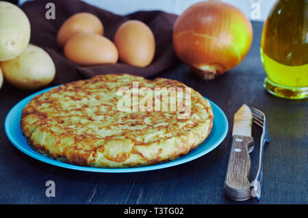 Spanish omelette with potato, egg and onion, accompanied by olive oil Stock Photo