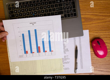 Performing data analysis using laptop computer spreadsheet software and graphical output. Stock Photo