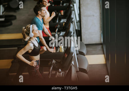 Top view at group of young people running on treadmills in modern sport gym Stock Photo