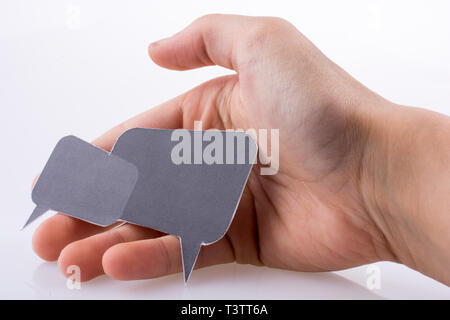 Hand holding dialogue boxes on a white background Stock Photo