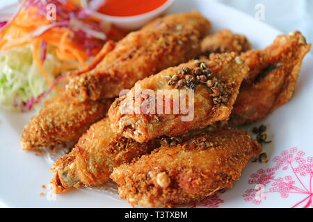Northern Thai Style Deep Fried Chicken Wing with Hot and Spicy Herbs Stock Photo