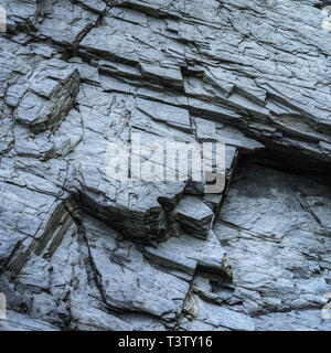 Texture of a slate rock, dark color and rectilinear cracks pattern Stock Photo