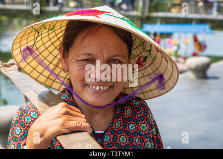 Portrait of an elderly Vietnamese woman wearing a traditional sampan hat also known as a 'rice hat'. Hoi An, Quang Nam Provence, Vietnam, Asia Stock Photo