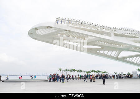 People enjoy the cloudy day beside The Museum of Tomorrow ( Museu do Amanha ) at Pier Maua, next to the  revitalized Praca Maua ( Maua Square ) in Rio de Janeiro downtown, Brazil, a former degraded area of urban violence and prostitution, as part of the Porto Maravilha Project ( Marvelous Port Program ), a revitalization project of the city Port Zone. Stock Photo