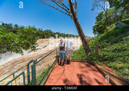 Man and woman on the Saltos del Monday a waterfall near the city Ciudad del Este in Paraguay Stock Photo