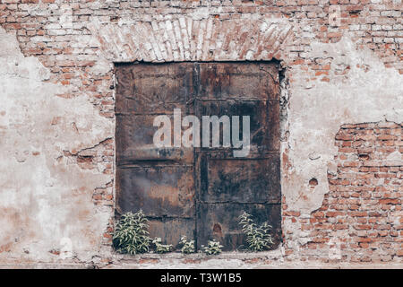 Old red and white brick wall urban texture background and metal door Stock Photo
