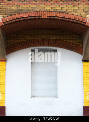 The window under the brick arch is closed Stock Photo