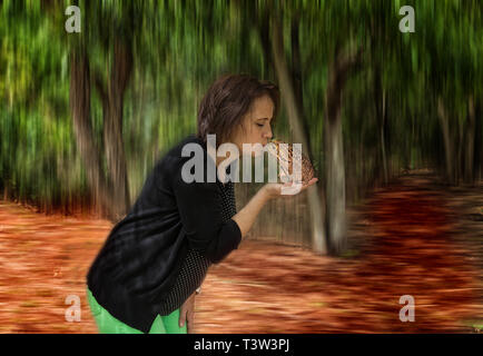 A woman kiss a frog. Stock Photo