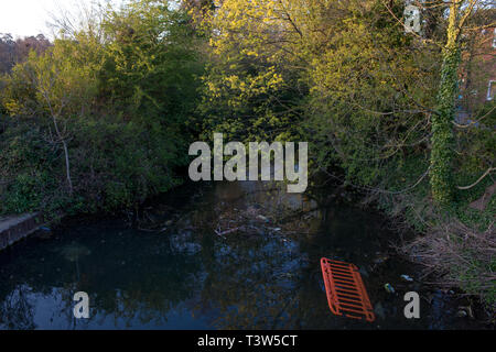Rubbish dumped in the River Lee in Hartham Common. The River Lee is in Hertford in the east of England and meets the River Thames. Stock Photo