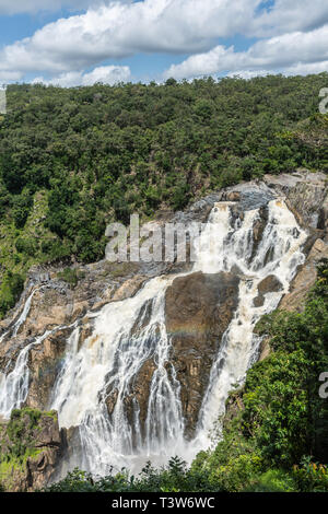 Cairns, Australia - February 18, 2019: Barron falls and white rapids in Kuranda green Rain Forest. Blue sky with white cloudscape. Stock Photo