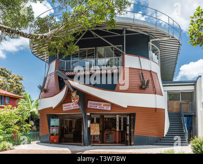 Cairns, Australia - February 18, 2019: Facade and special ship-like architecture of Doongal Aboriginal art shop and gallery downtown Kuranda Village. Stock Photo