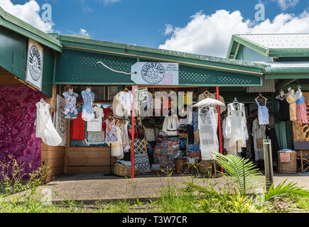 Cairns, Australia - February 18, 2019: Storefront of clothing store downtown Kuranda village. Facade pretty much covered by dresses and shirts on disp Stock Photo