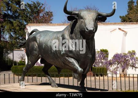 Ronda, Andalucia, Spain - March 16, 2019 : bronze statue of a fighting bull situated outside the historic bullring in Ronda, Spain Stock Photo