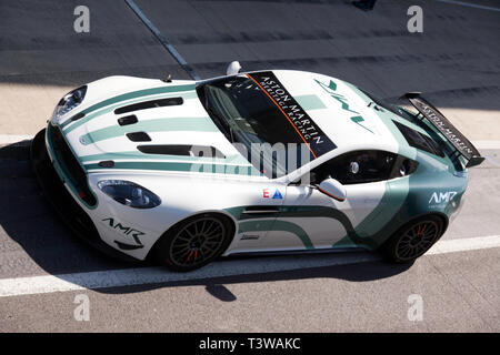 Aerial view of an 2015, Aston Martin Vantage GT4,  exiting the pit lane at the 2019 Silverstone Classic Media/Test Day Stock Photo